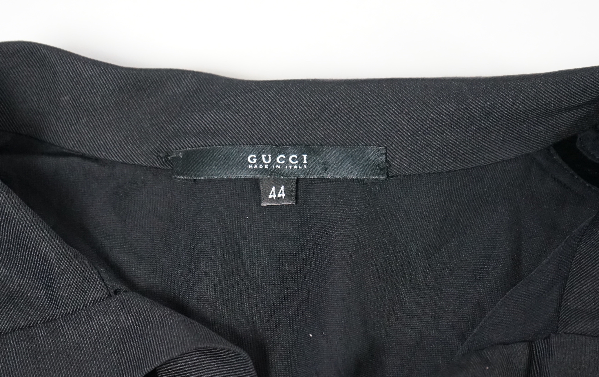 A pair of Gucci lady's textured satin trousers with gold tone diamante snaffle detail to the back and a Gucci velvet blouse, Gucci trousers: size 40, blouse size 44